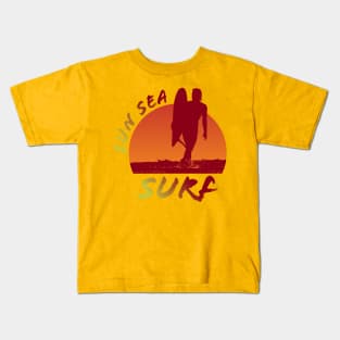 Sun Sea and Surf with surfer silhouette over sunset Kids T-Shirt